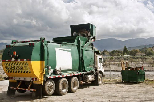 People loading construction waste into a skip in Norwood